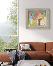 Load image into Gallery viewer, David Wien Stone House Painting in a thick grey wooden frame on a small wall next to a window with a midcentury modern couch

